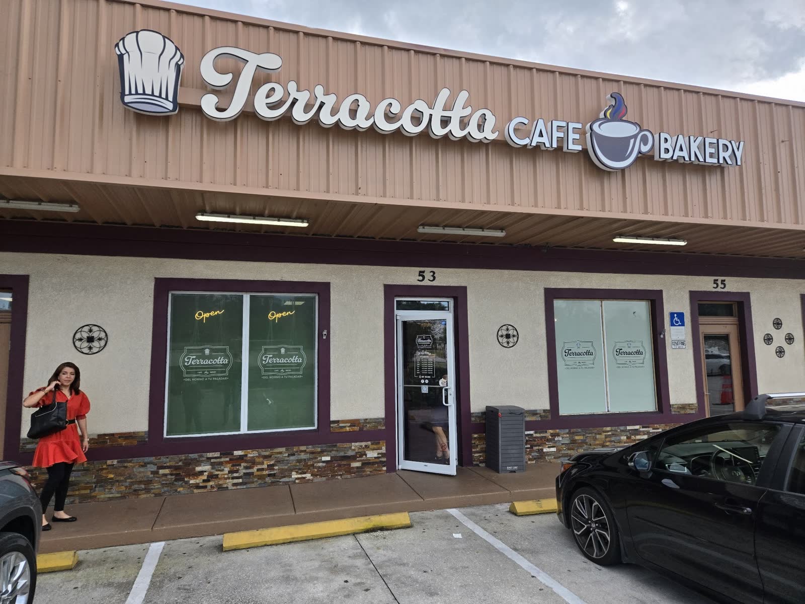Terracotta Cafe & Bakery storefront from the parking lot, terracotta awning and beige stucco